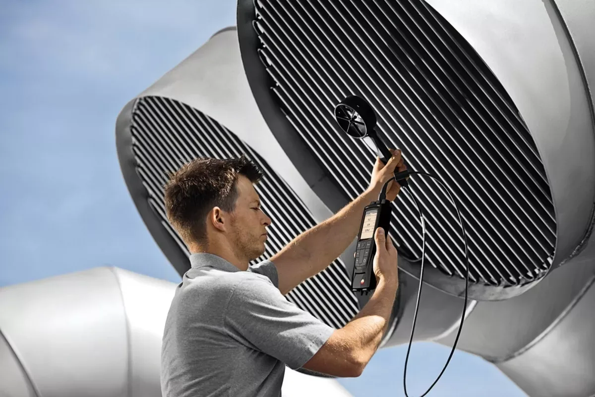 Technician measuring vent airflow in a New Orleans home