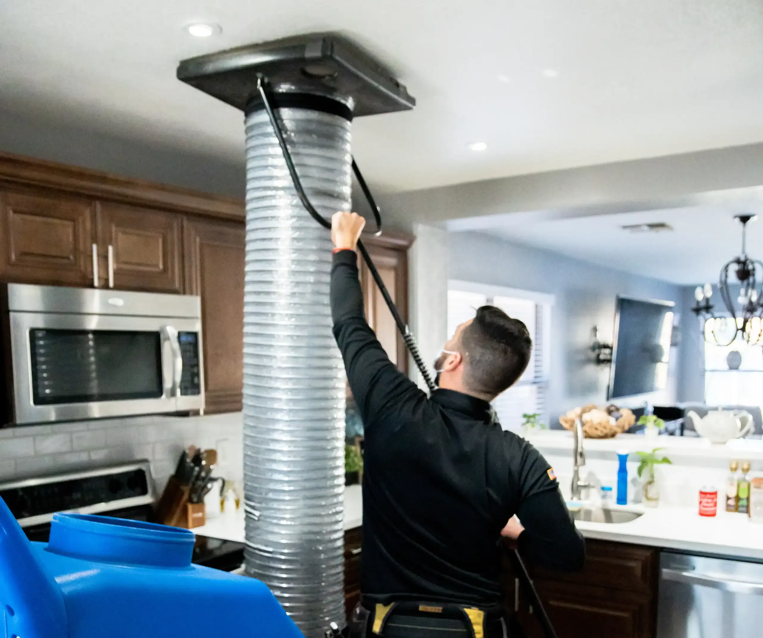 Technician setting up professional duct cleaning equipment in a New Orleans home