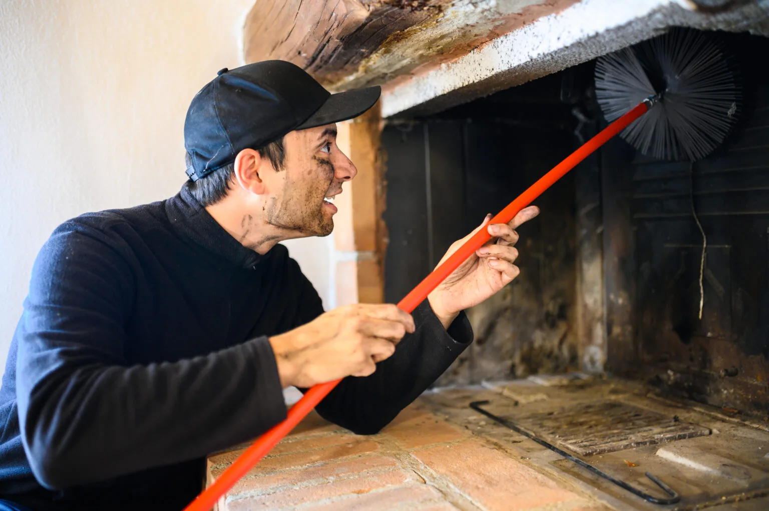Chimney sweep servicing a fireplace in New Orleans